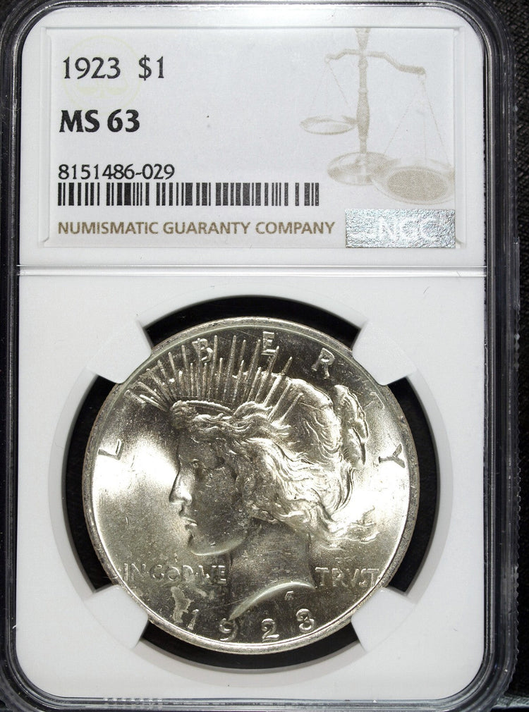 "Collection of historical Peace Silver Dollars (1921-1935), showing both professionally graded and ungraded coins."