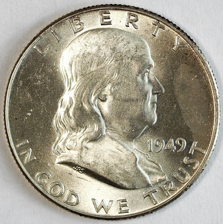 "Various US Half Dollar coins from 1817 to present, including graded and ungraded examples."
